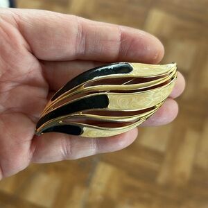 Trifari Gold and Black Brooch with enamel swirl design